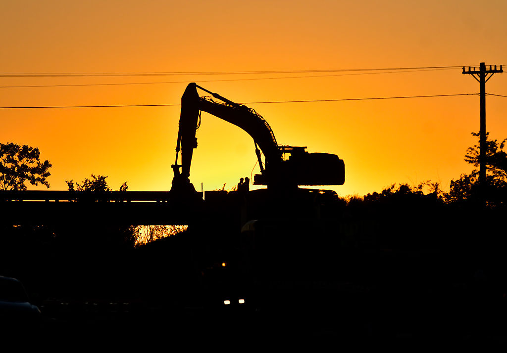 An excavator on the overpass bridge